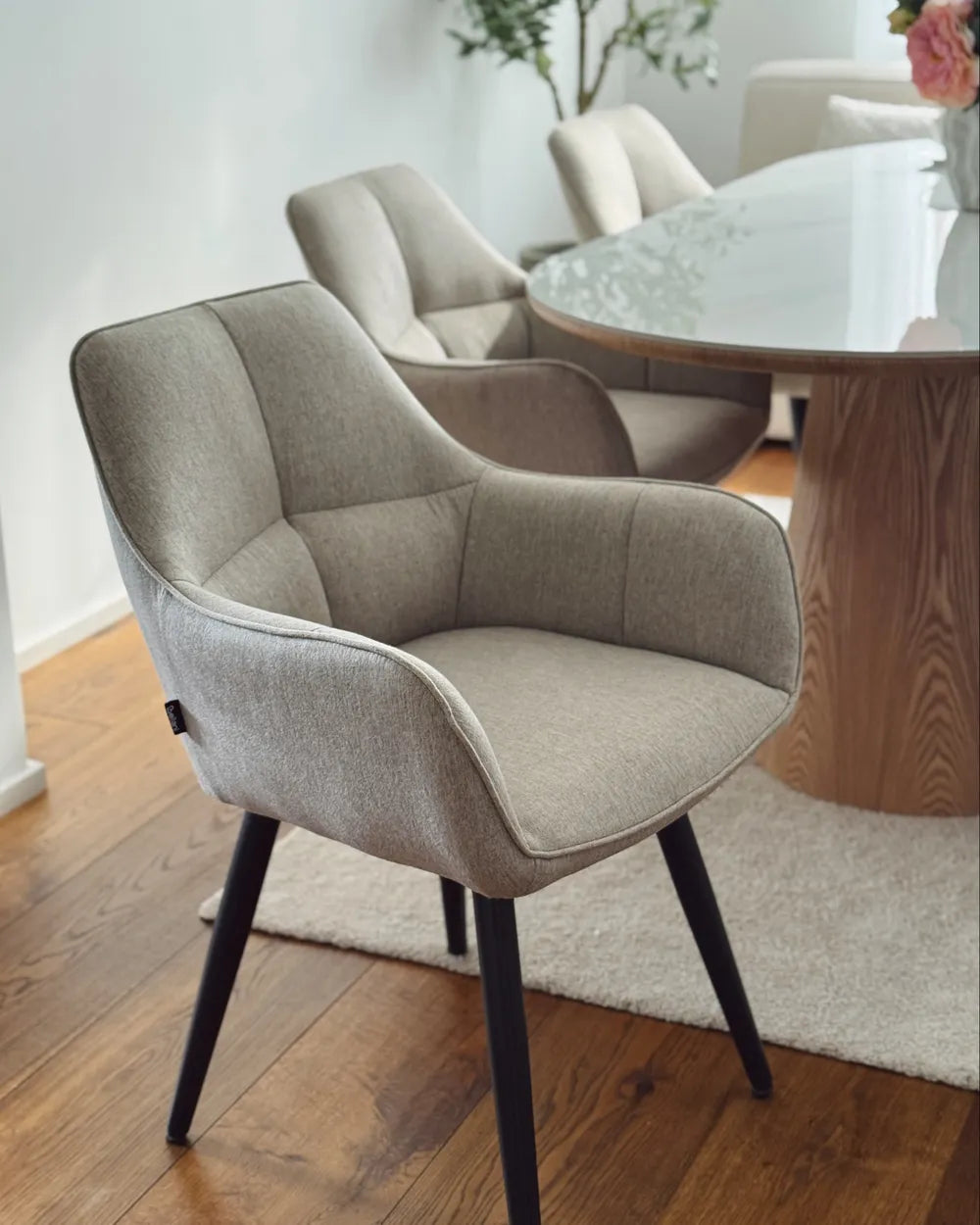Dining room with a wooden table and beige chairs.