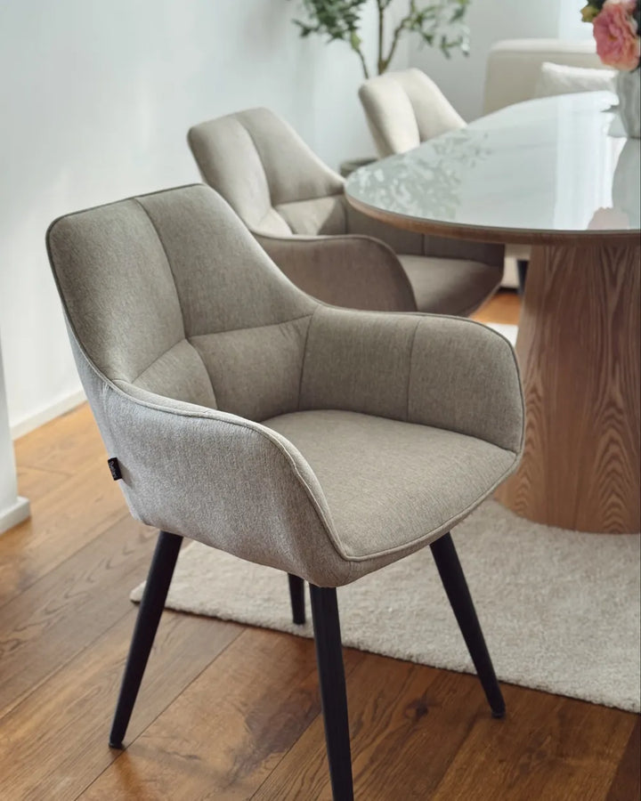Dining room with a wooden table and beige chairs.