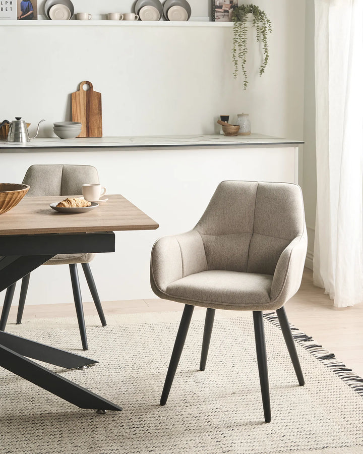 Dining room with a wooden table and beige chairs.