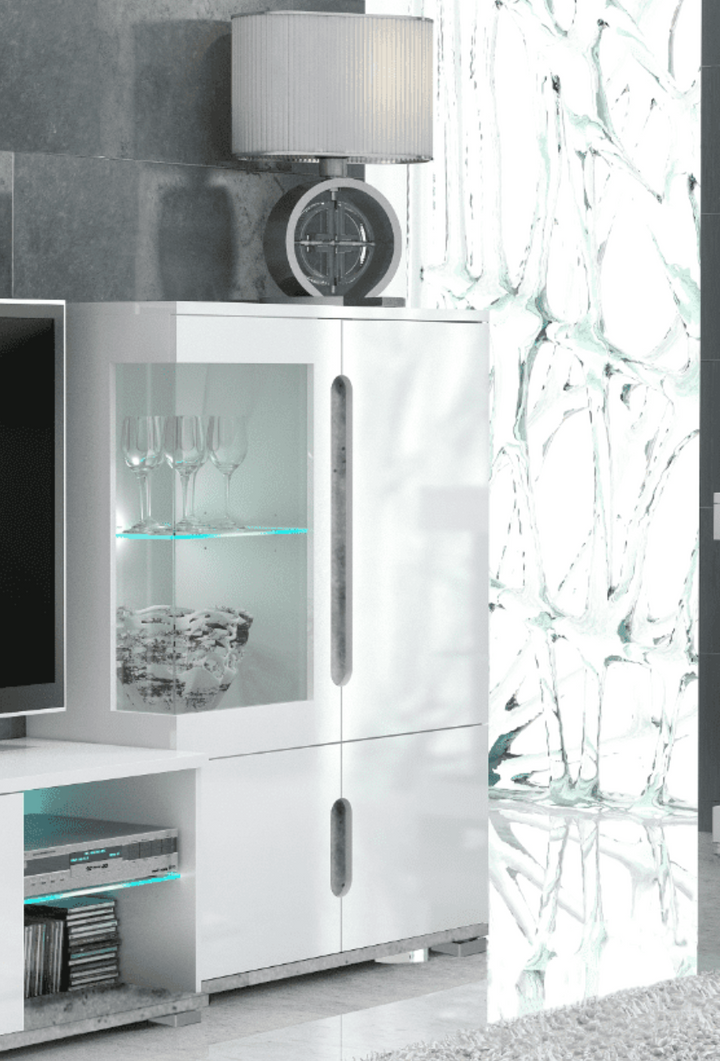 Modern white entertainment console with glass shelves and decorative items in a living room setting.