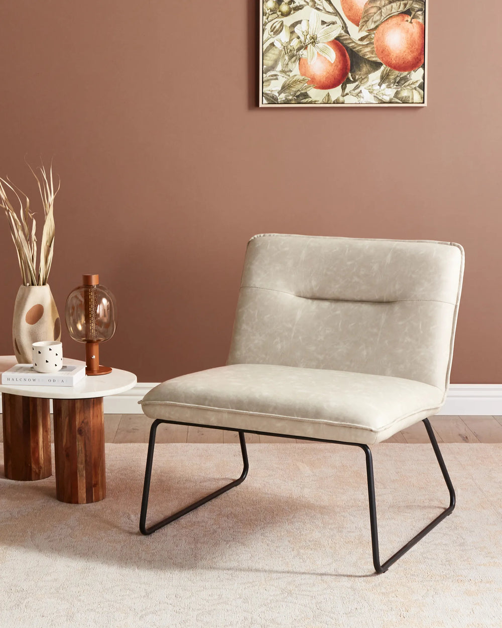 Beige armchair in a room with a brown wall and decorative elements.
