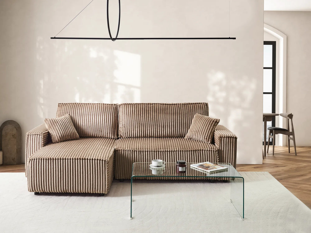 Modern living room with a striped sofa and glass coffee table.