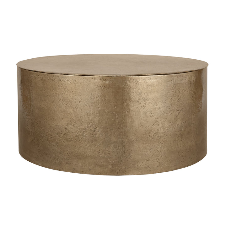 Round metallic gold coffee table on a white background