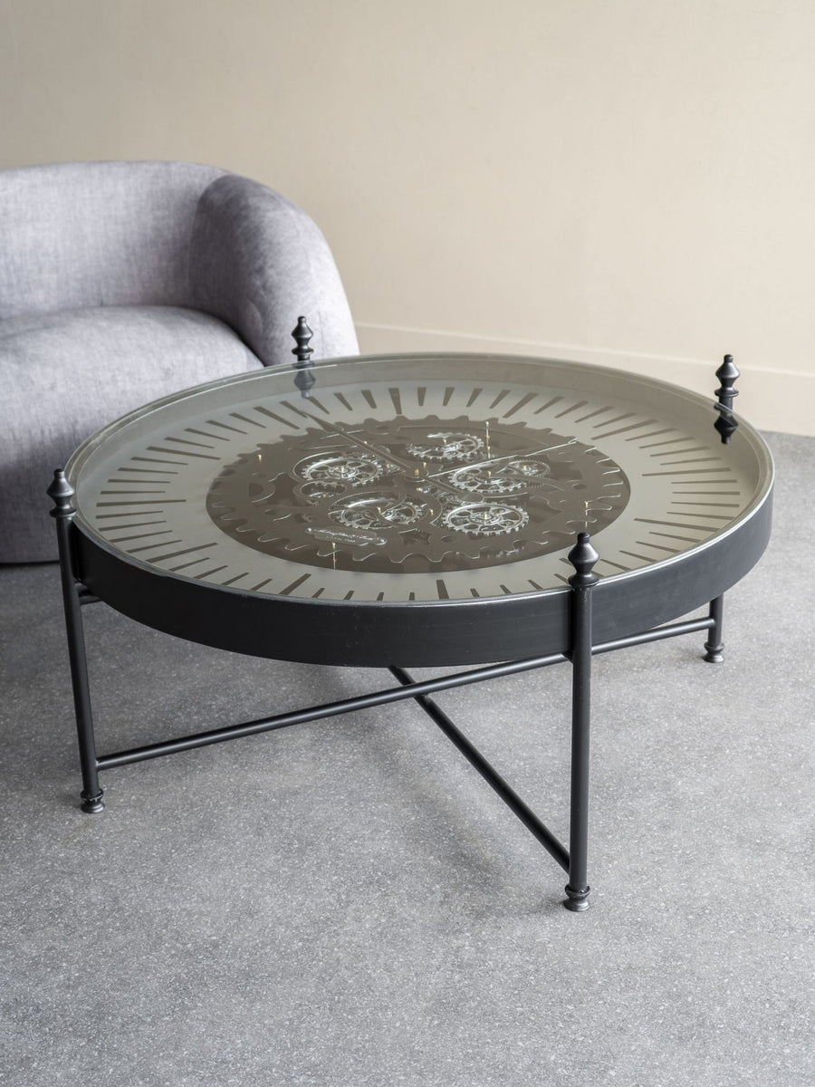 Round coffee table with decorative design in a living room setting