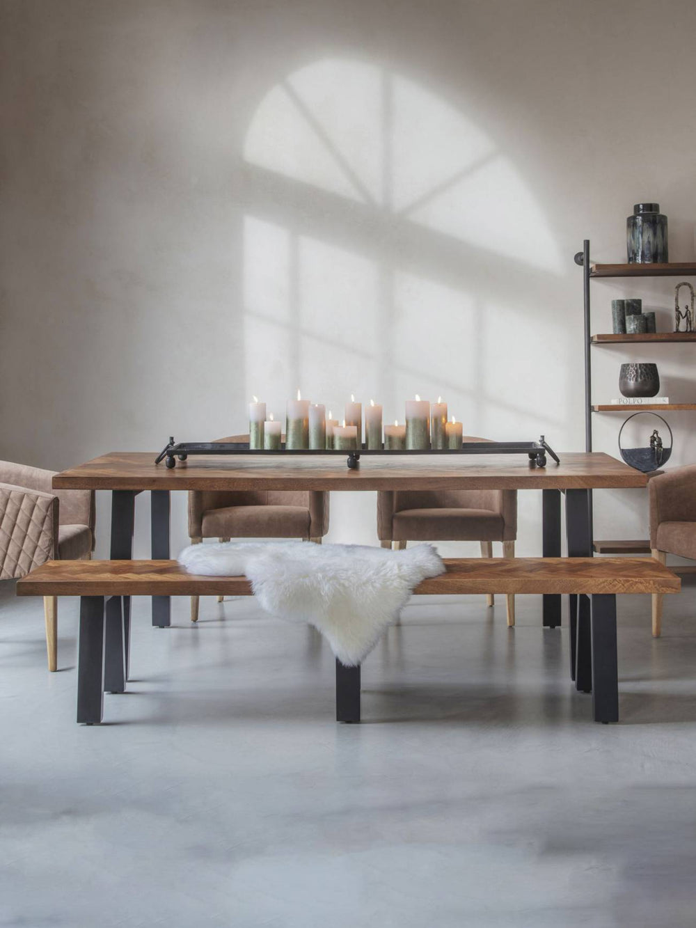 Dining room with wooden table, chairs, and benches in a modern interior setting.
