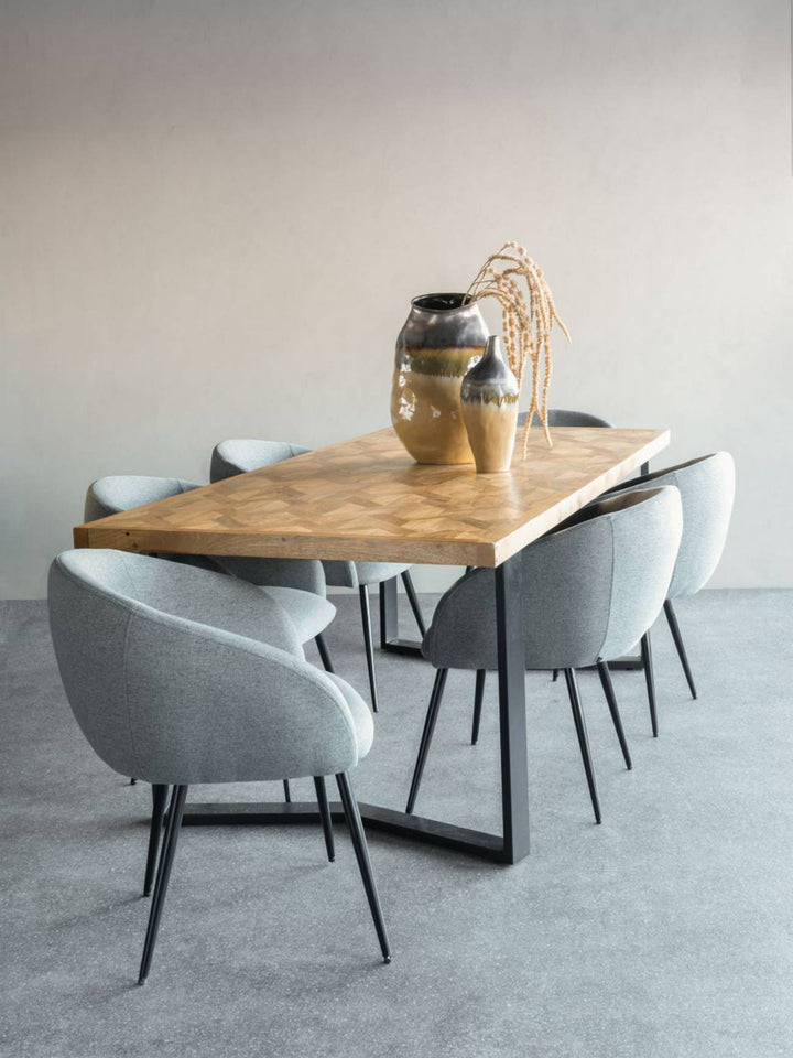 Dining area with wooden table and gray chairs in a minimalistic setting