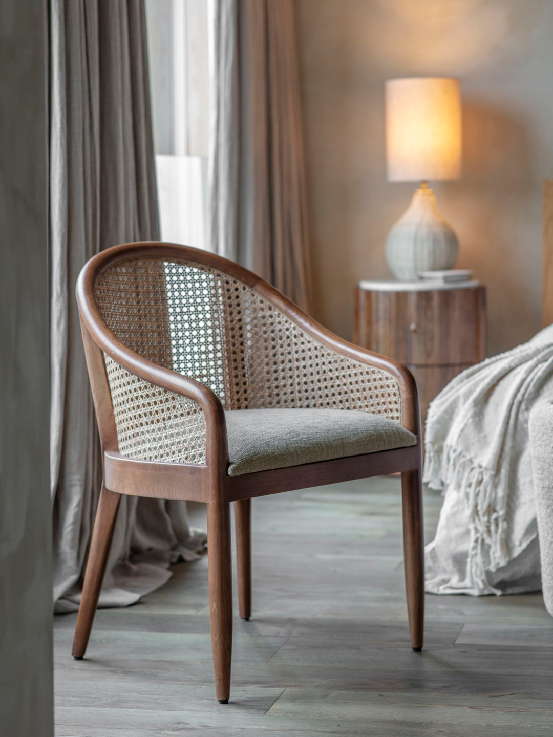 Wicker chair with a cushion in a bedroom setting