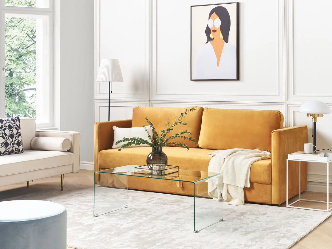 Modern living room with a yellow sofa, glass coffee table, and decorative elements.