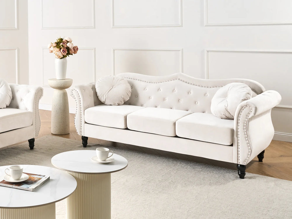 Elegant beige velvet sofa with nailhead trim details