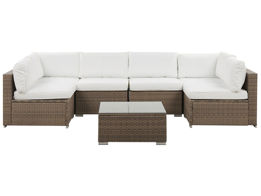 A six-seater modular corner sofa with white cushions and a brown rattan frame, accompanied by a square coffee table with a glass top.