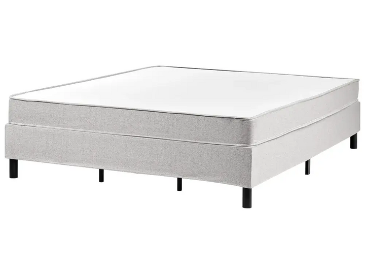 Gray bed frame with mattress on a white background