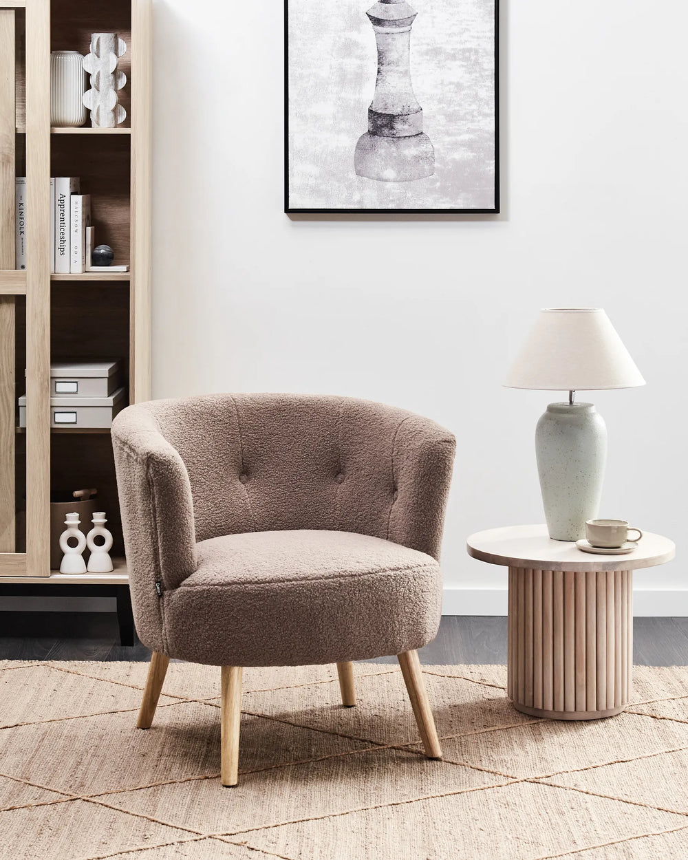 Cozy corner with a brown armchair, side table, and bookshelf in a modern living room.