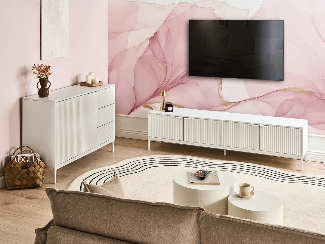 Modern living room with a TV mounted on a decorative wall, white furniture, and a brown sofa.