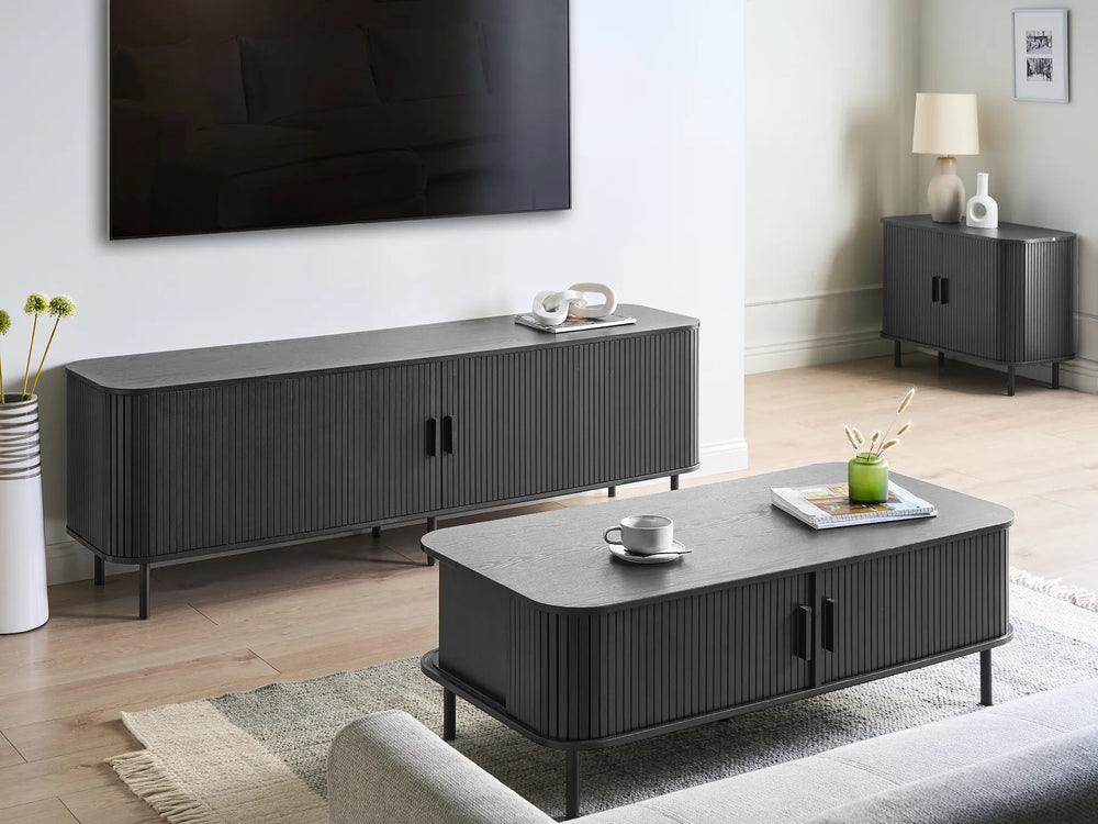 Modern living room with gray TV stand and coffee table, featuring a television on the wall.