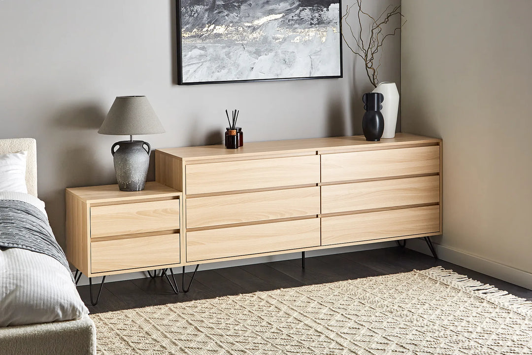 Wooden dresser in a bedroom with decor items on top