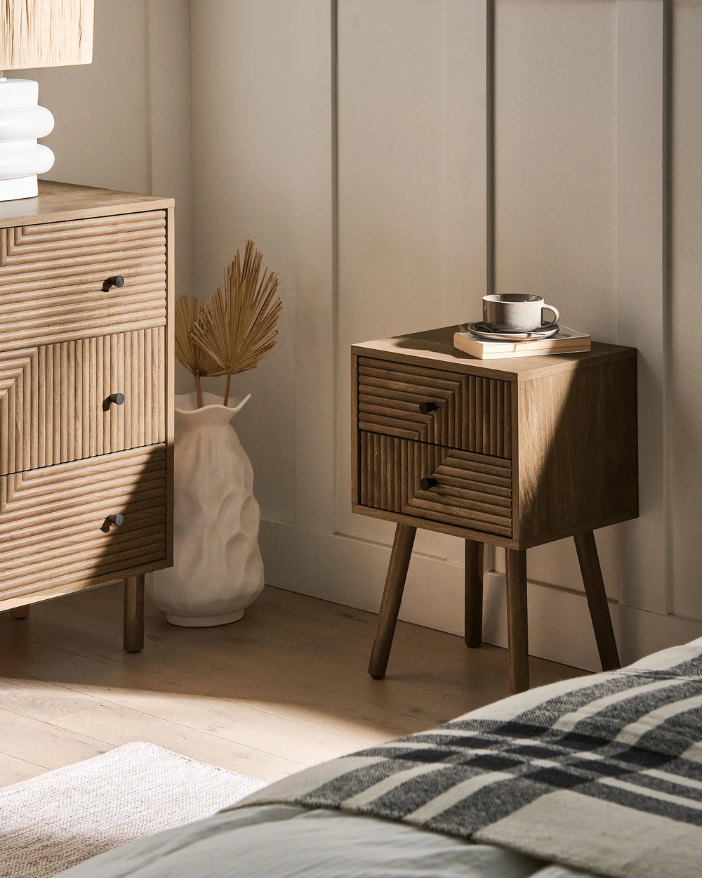Wooden nightstands with decorative items in a bedroom setting