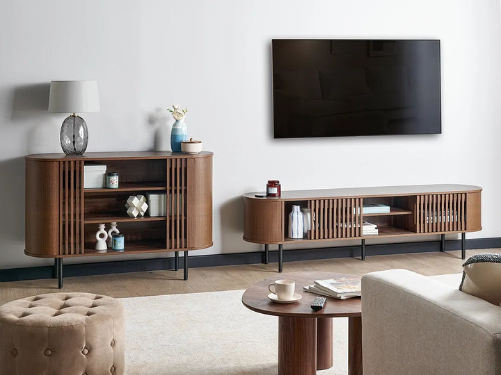 Modern living room with wooden entertainment units, a TV, and decorative items.