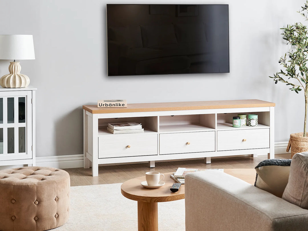 Living room with a wooden TV stand, sofa, ottoman, and coffee table.