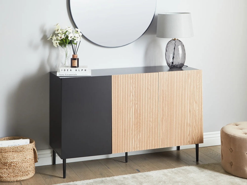 Modern sideboard with wooden and black panels in a room setting.