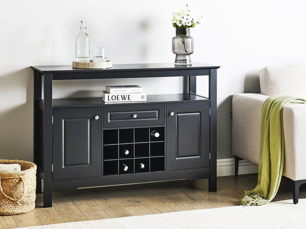 Black console table in a living room setting with decor items on top