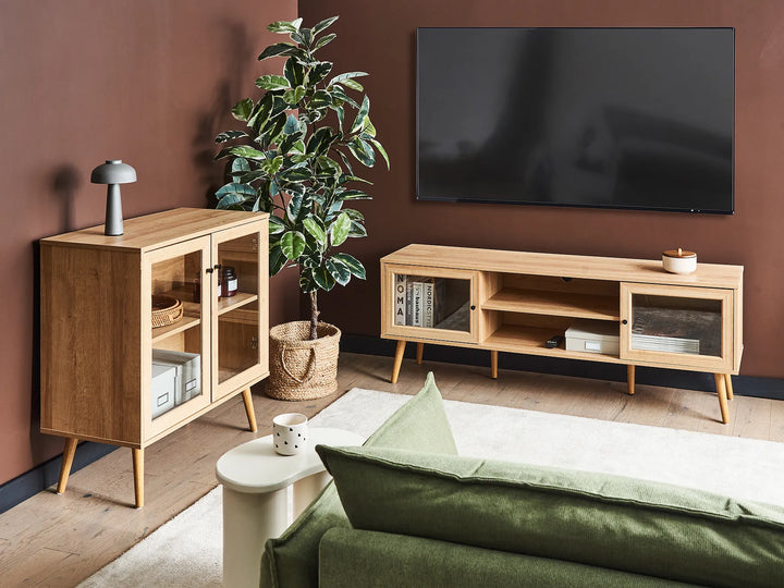 Modern living room with wooden furniture, TV, and decorative items.