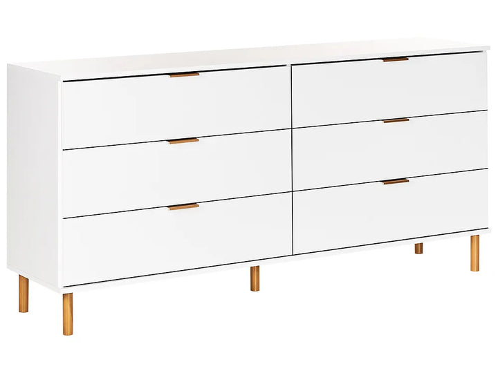 A modern white six-drawer dresser with slim gold-toned metal drawer pulls and light wood legs, shown against a plain white background.