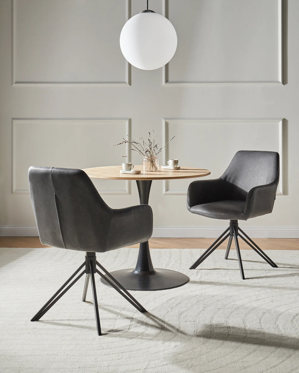 Pair of black leather-look dining chairs with backrests