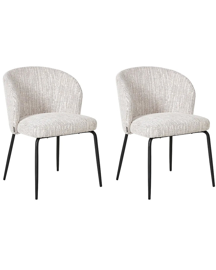 Two matching upholstered dining chairs with curved backs, textured light beige fabric seats, and slim black metal legs, shown on a plain white background.
