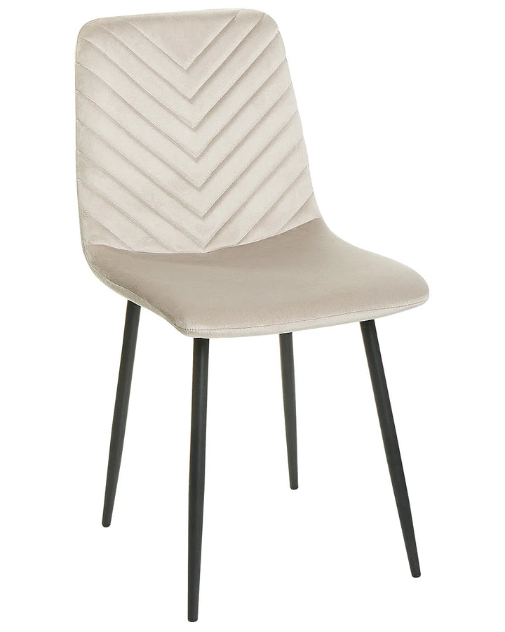A modern dining chair with a cream-colored velvet upholstered seat and backrest featuring a chevron pattern, supported by four slim black metal legs, shown against a plain white background.