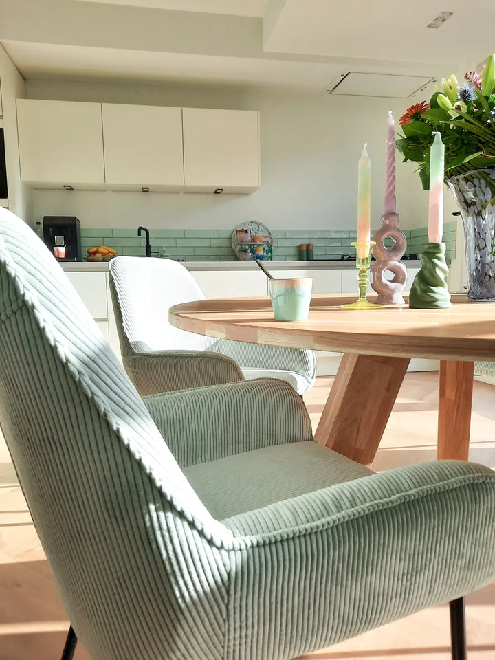 Mint green corduroy dining chairs with textured fabric