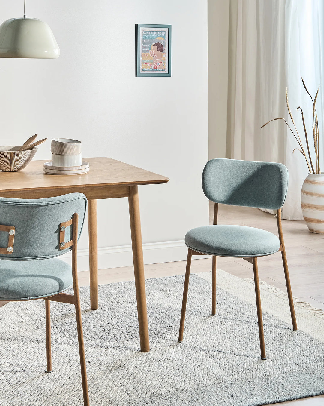 Mint green dining chairs with wood-effect legs
