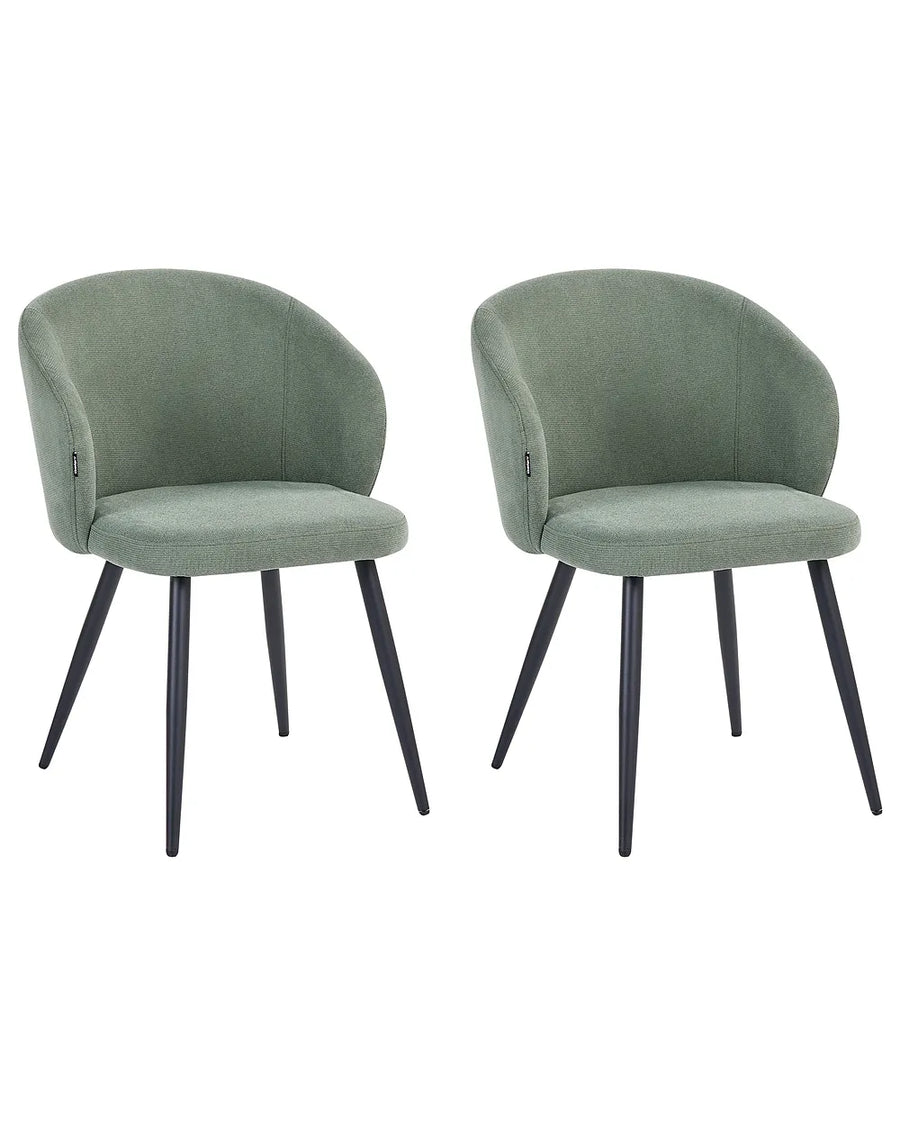 Two matching upholstered accent chairs with rounded backs and seats, in a muted sage green fabric, with tapered black metal legs, shown against a plain white background.