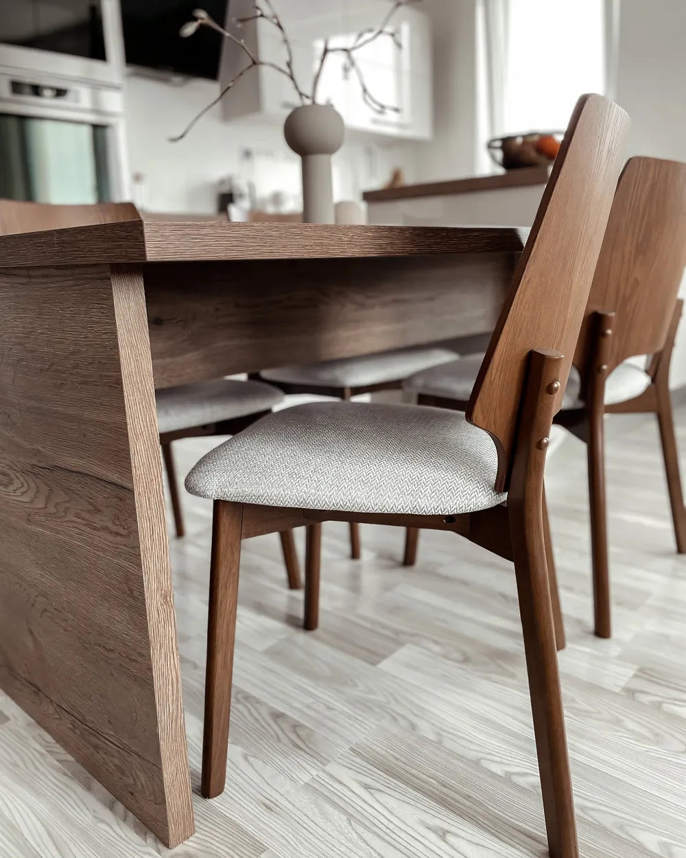 Dining table with wooden chairs in a modern kitchen setting