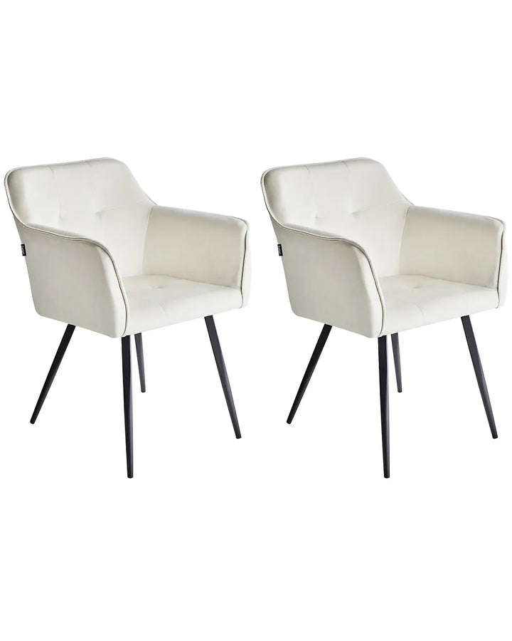 Two modern upholstered dining chairs with cream faux leather seats and black tapered legs, shown side by side on a white background.