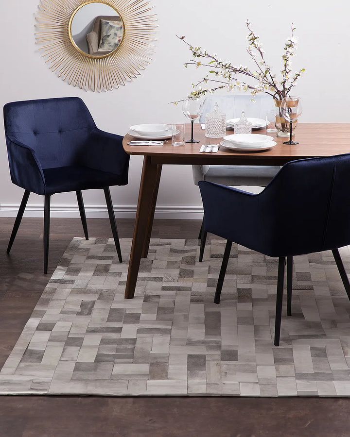 Dining room with a wooden table, navy chairs, and decorative elements.