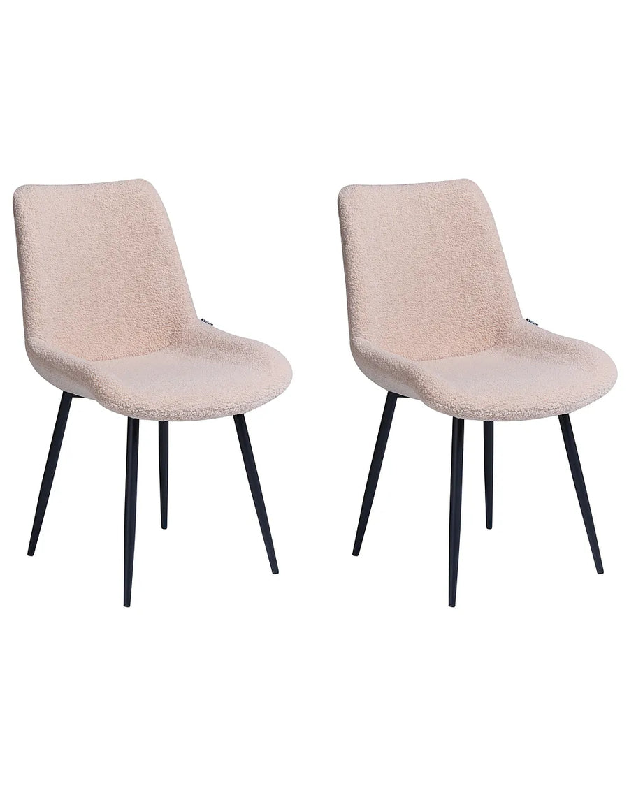 Two modern dining chairs with textured blush pink bouclé upholstery and slim black metal legs, shown side by side on a plain white background.
