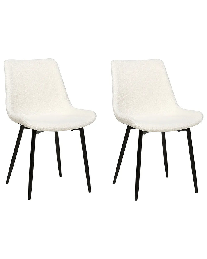 Two modern dining chairs with white textured upholstered seats and slim black metal legs, shown side by side on a plain white background.