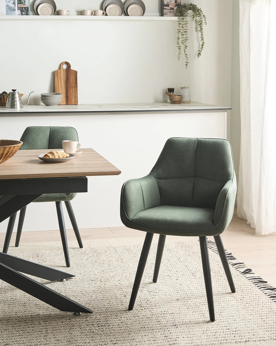 Green chair with black legs