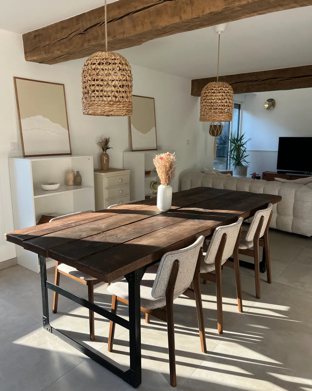Dining area with a wooden table and chairs in a modern living room.