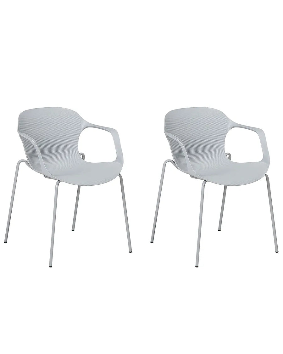 Two modern white armchairs with slim metal legs, shown side by side against a plain white background.