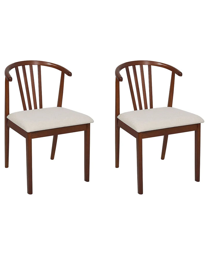 Two wooden dining chairs with curved backrests and light beige upholstered seats, shown on a plain white background.