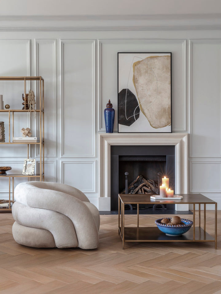 Modern living room with a fireplace, abstract art, and decorative items.