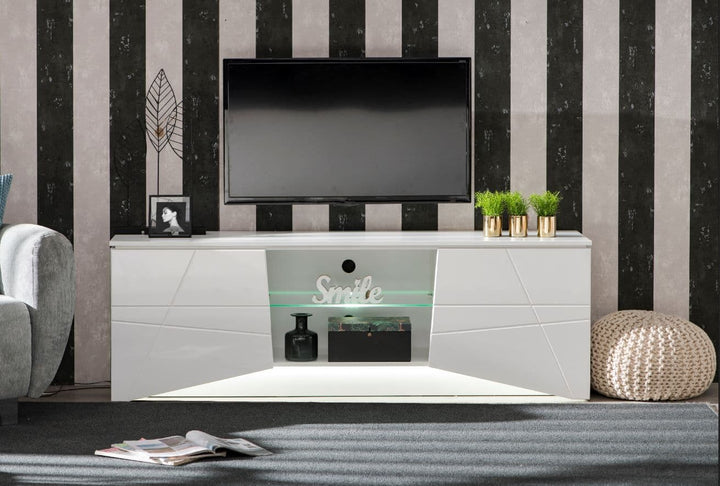 Modern living room with a white entertainment console, TV, and decorative items against a striped wall.