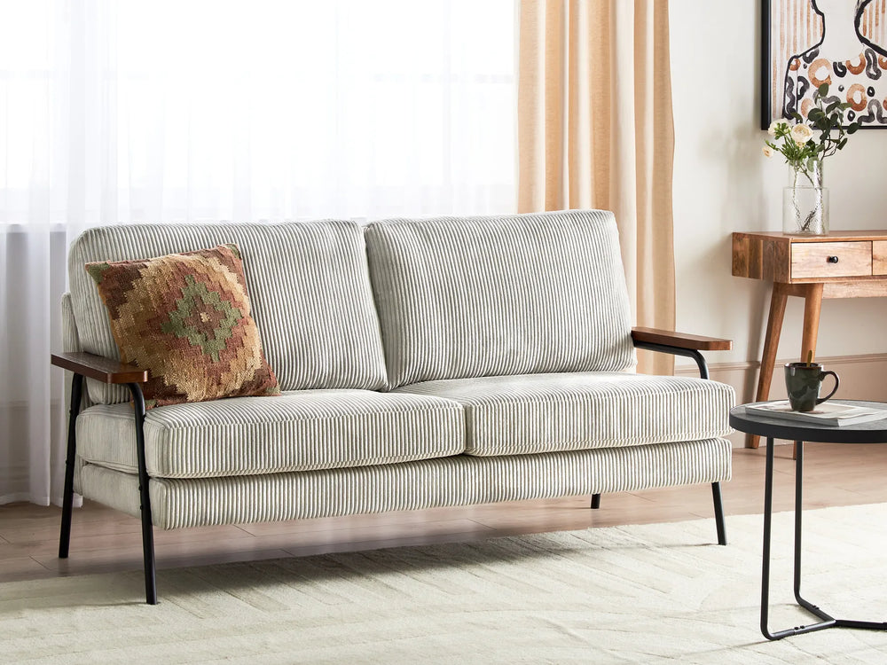 Light gray striped sofa with a decorative pillow in a living room setting.