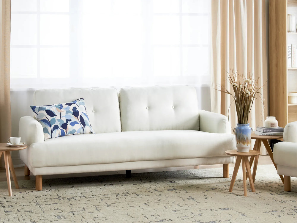 White sofa with a decorative pillow in a living room setting