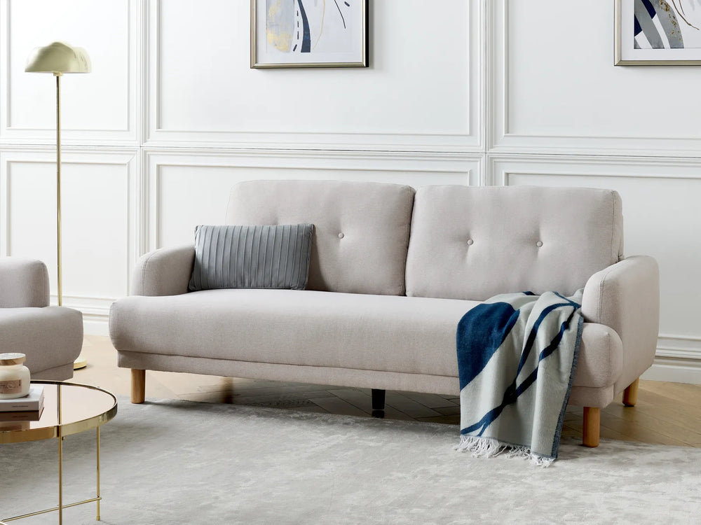 Modern taupe upholstered three-seater sofa with padded cushions