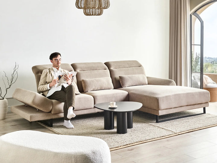 4‑seater taupe L‑shaped corner sofa with plush cushioning and adaptable armrests in modern living room