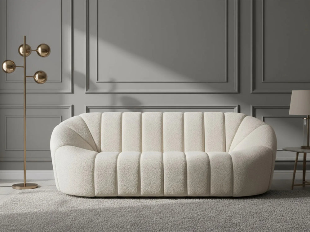 White sofa in a room with gray walls and a gold floor lamp.