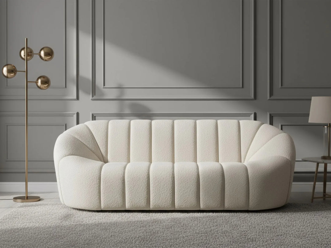 White sofa in a room with gray walls and a gold floor lamp.