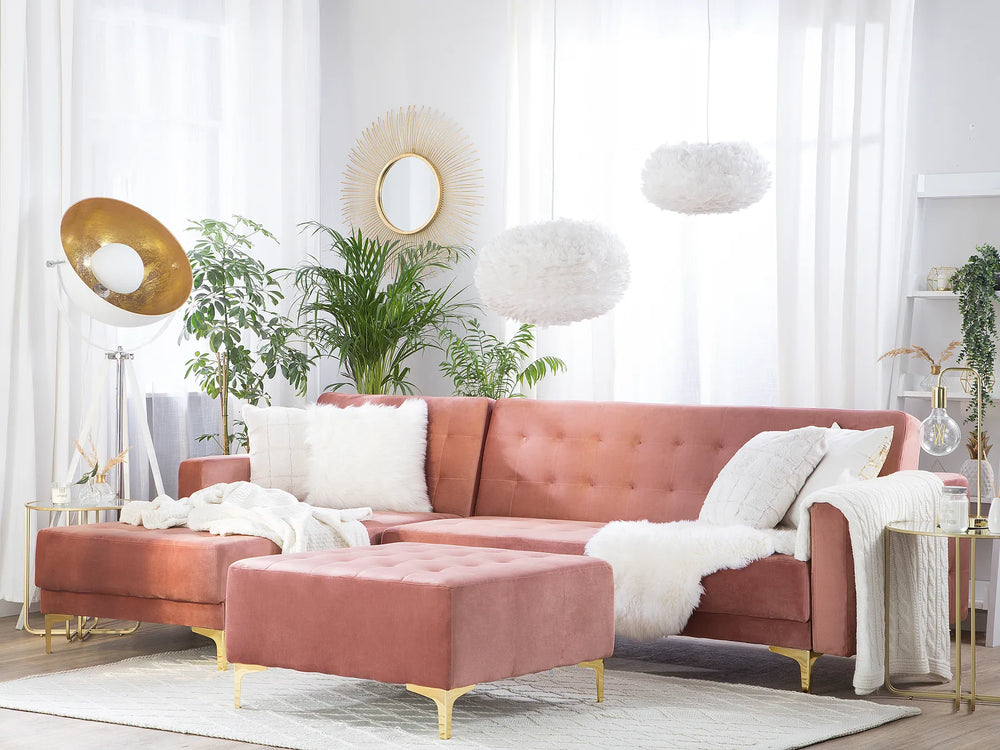 Pink sectional sofa in a stylish living room with decor elements.